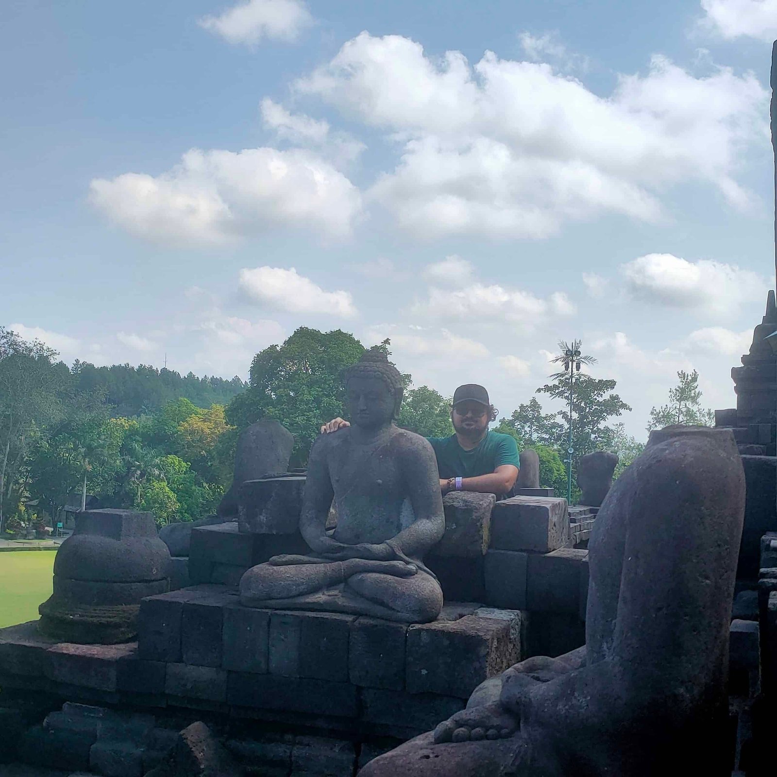 Borobudur temple Buddha statue on upper terrace with clouds April 2026